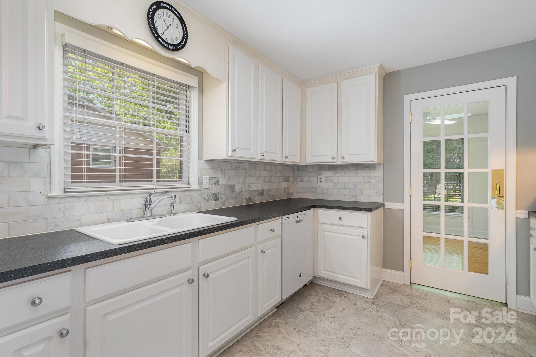 6529 Idlebrook Drive Charlotte, NC 28212 - Photo 17 of 28 a kitchen with granite countertop a sink and a window