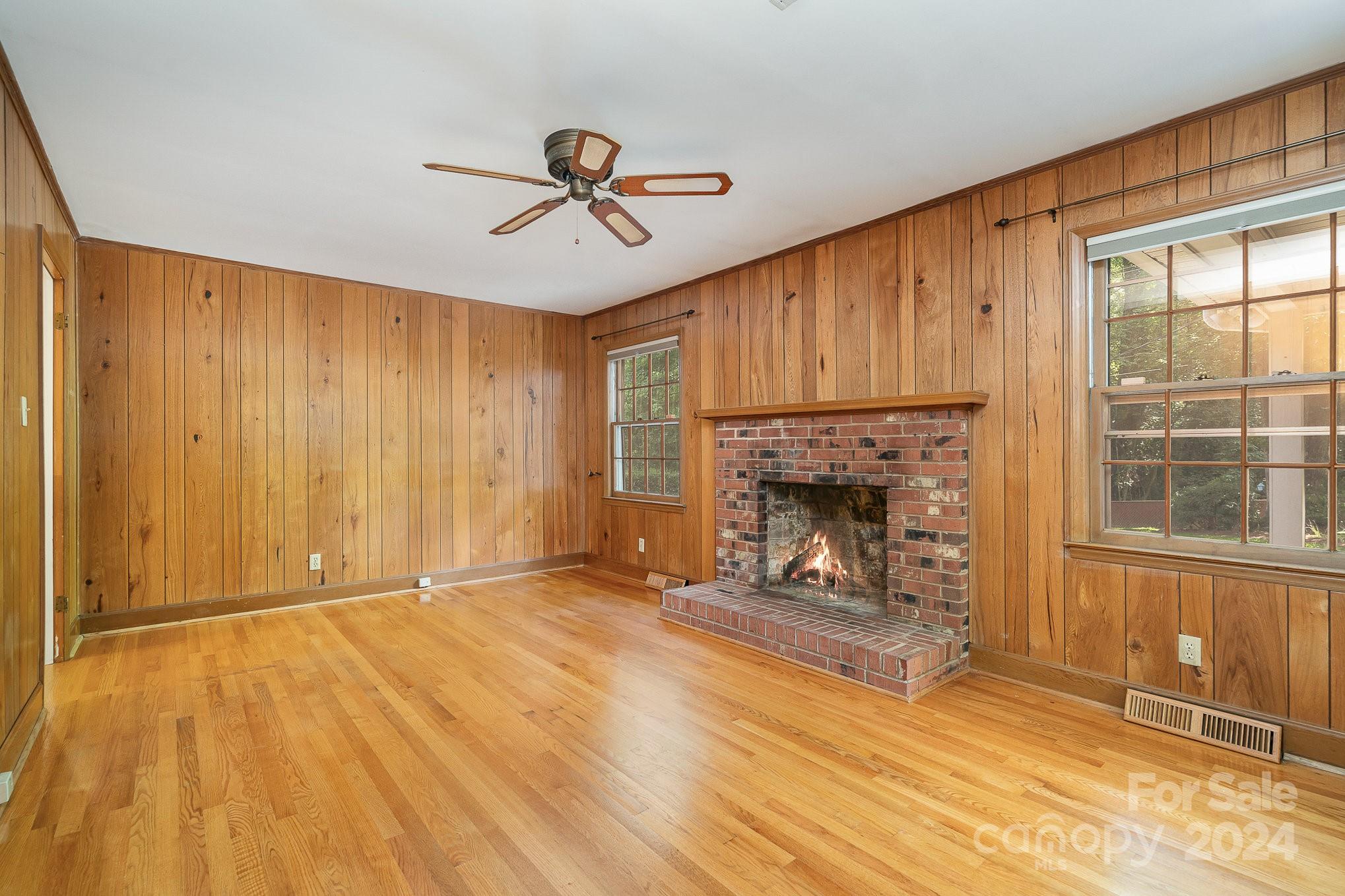 6529 Idlebrook Drive Charlotte, NC 28212 - Photo 21 of 28 a view of an empty room with a fireplace and a window
