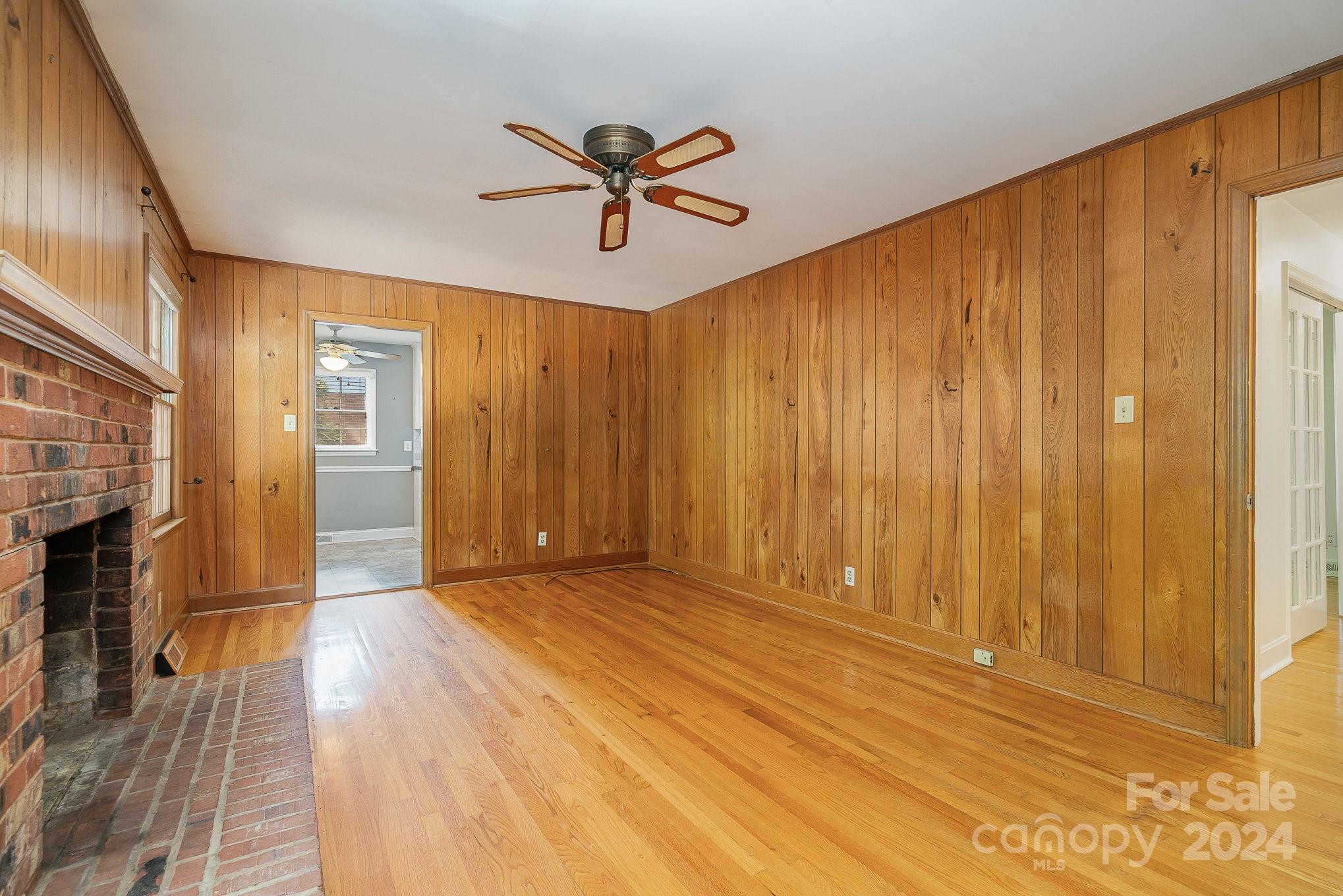 6529 Idlebrook Drive Charlotte, NC 28212 - Photo 22 of 28 a view of empty room with wooden floor and fan