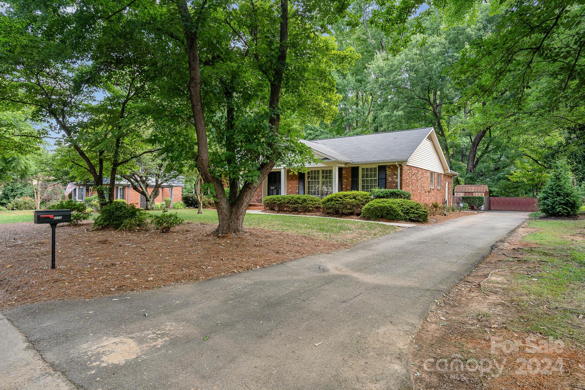 6529 Idlebrook Drive Charlotte, NC 28212 - Photo 4 of 28 a front view of a house with a yard and tree