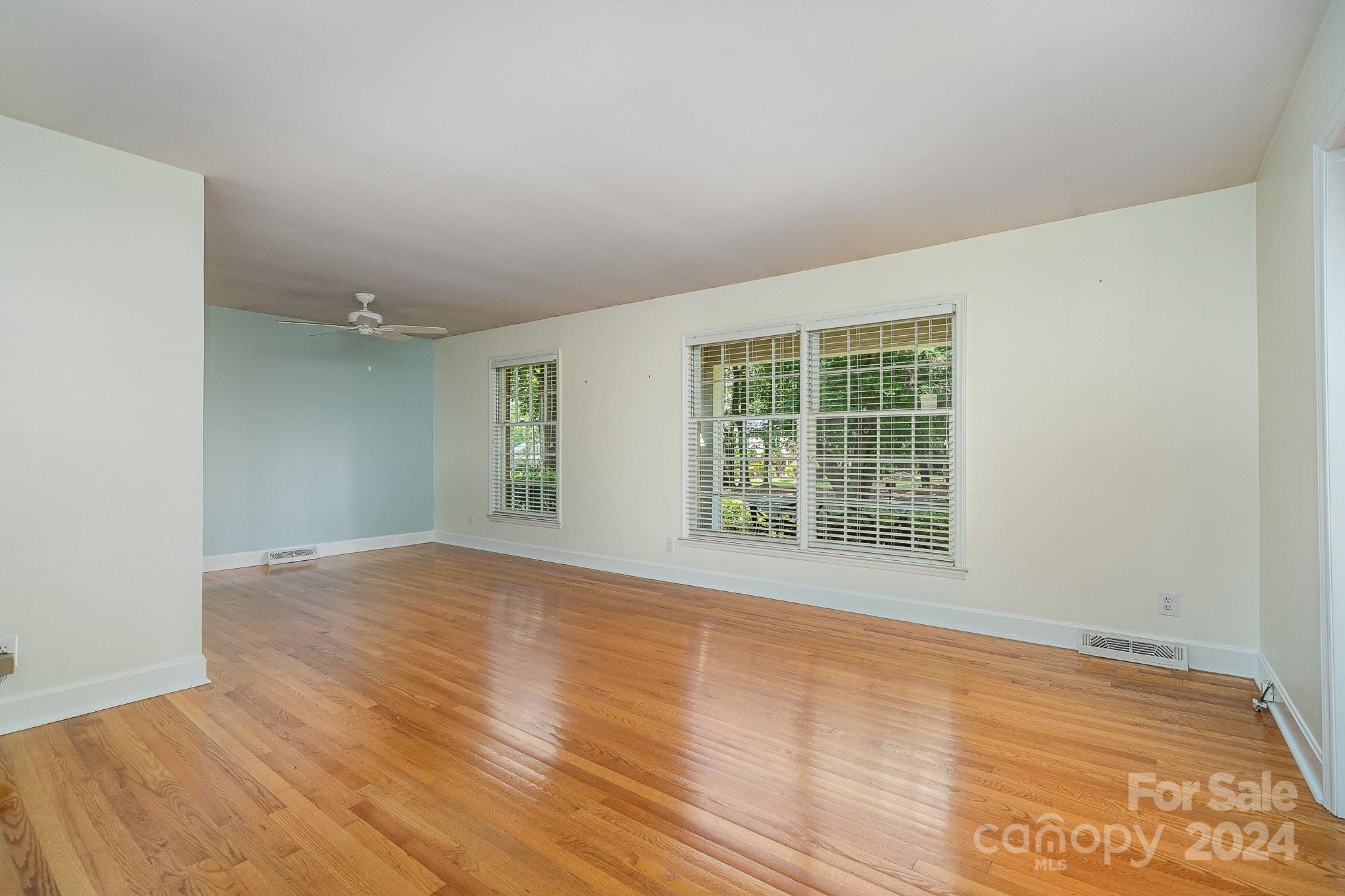 6529 Idlebrook Drive Charlotte, NC 28212 - Photo 7 of 28 a view of an empty room with wooden floor and a window