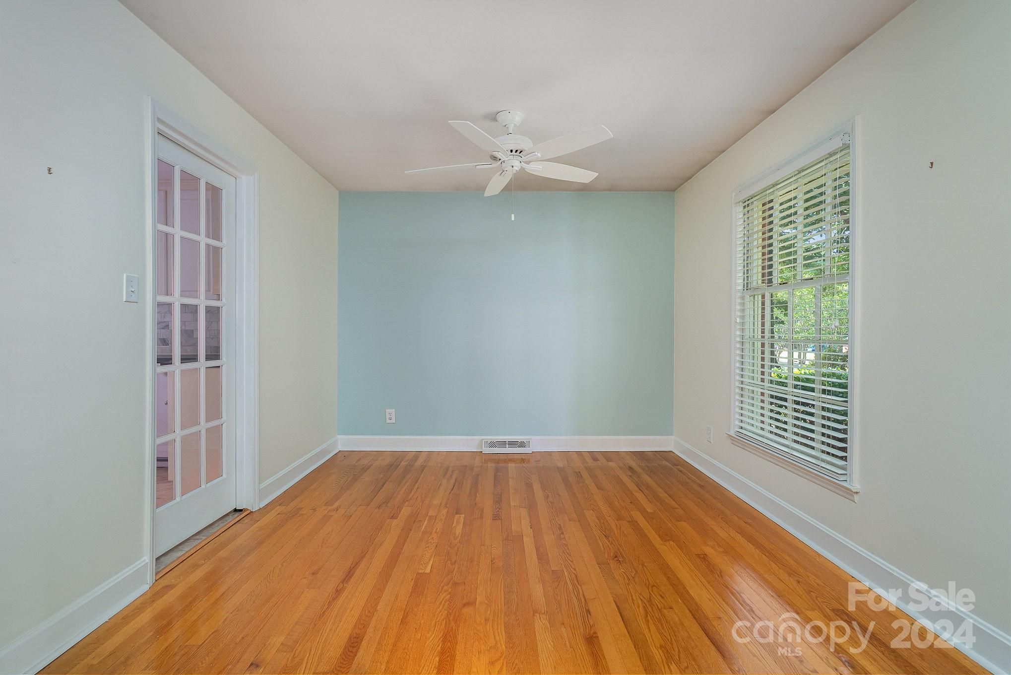 6529 Idlebrook Drive Charlotte, NC 28212 - Photo 8 of 28 wooden floor in an empty room with a window