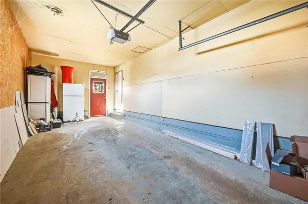a view of a room with a bed and wooden floor