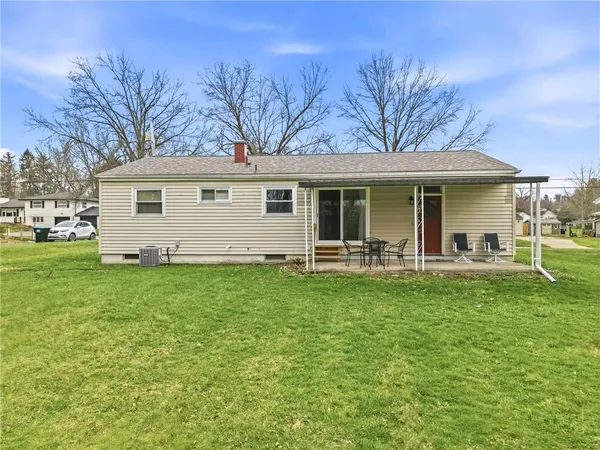 a front view of house with yard and green space