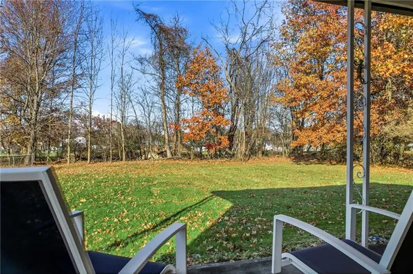 a view of a yard with wooden fence