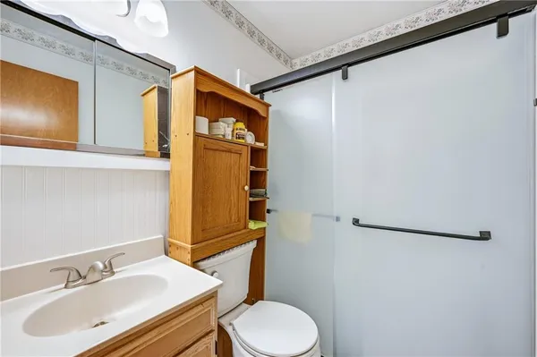 a bathroom with a sink toilet and shower
