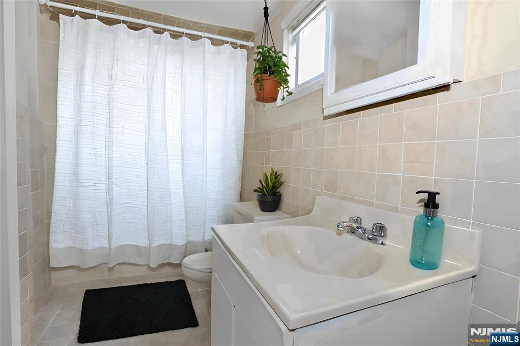 756 Hamilton Street, Unit 3 Harrison, NJ 07029 - Photo 4 of 7 a bathroom with a sink and a mirror