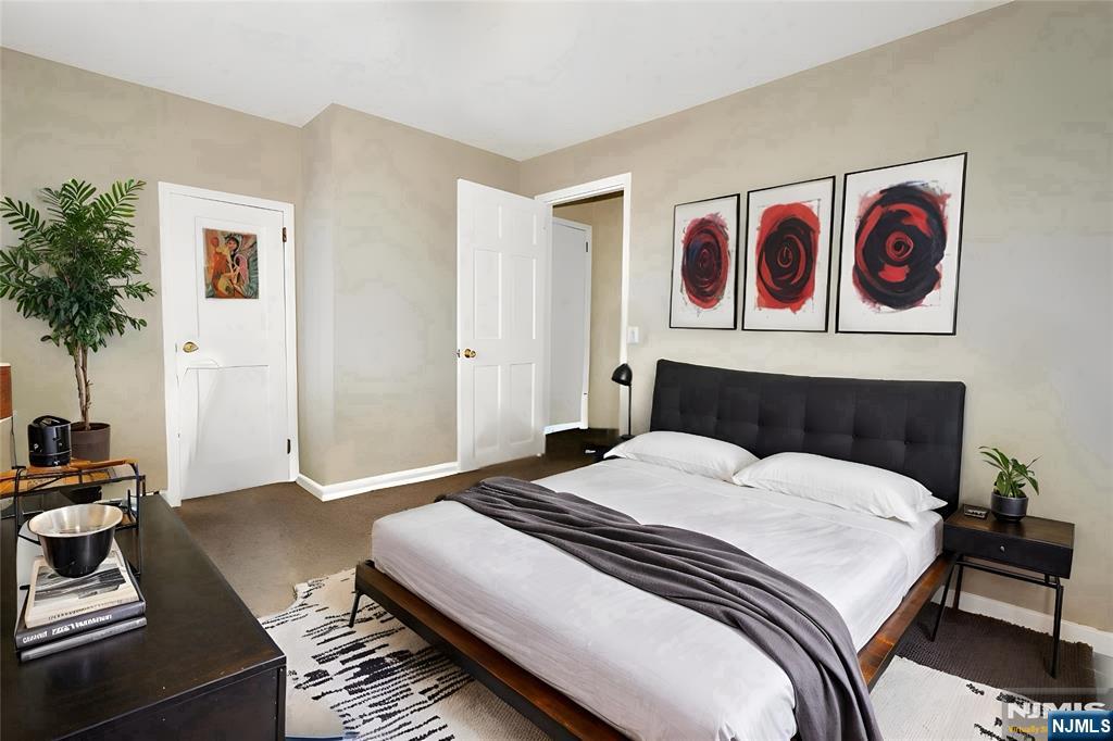 756 Hamilton Street, Unit 3 Harrison, NJ 07029 - Photo 5 of 7 a bedroom with a bed and paintings on the wall