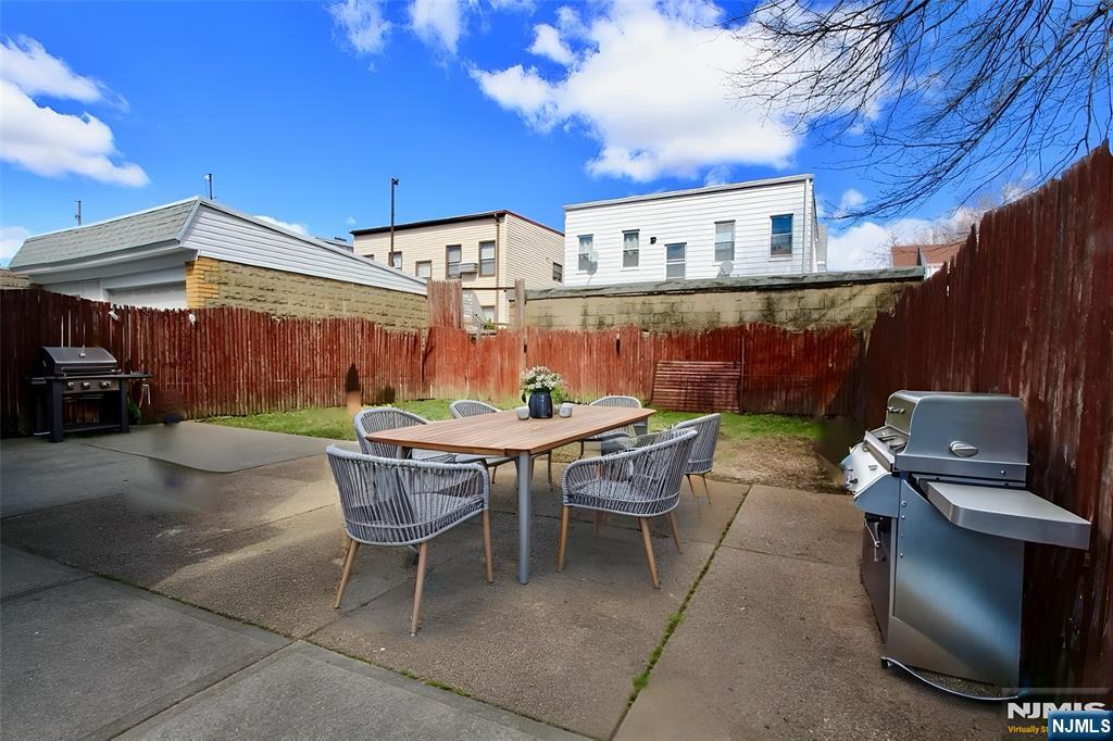 756 Hamilton Street, Unit 3 Harrison, NJ 07029 - Photo 7 of 7 a patio with a table and chairs