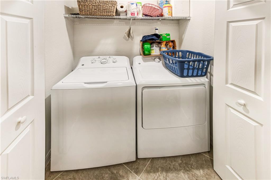 9572 Trevi Court, Unit 5015 Naples, FL 34113 - Photo 16 of 39 a utility room with dryer and washer