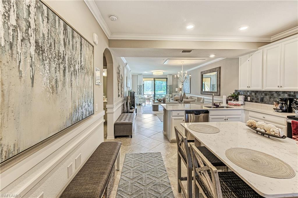 9572 Trevi Court, Unit 5015 Naples, FL 34113 - Photo 6 of 39 a large white kitchen with lots of counter space a sink and appliances