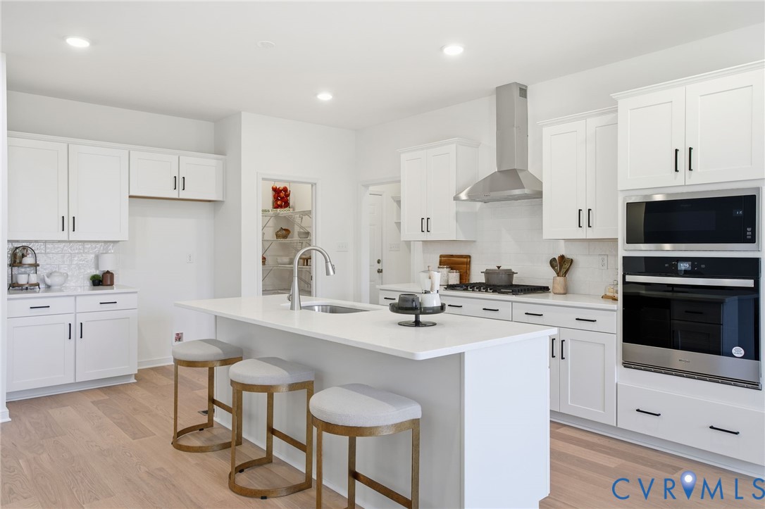 9991 Boschen Wds Place Chesterfield, VA 23832 - Photo 2 of 38 a kitchen with stainless steel appliances a stove a sink a stove a refrigerator and white cabinets