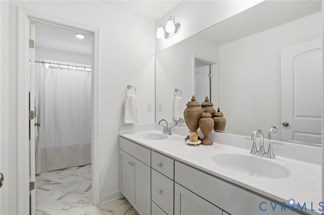 9991 Boschen Wds Place Chesterfield, VA 23832 - Photo 24 of 38 a bathroom with a double vanity sink mirror and shower