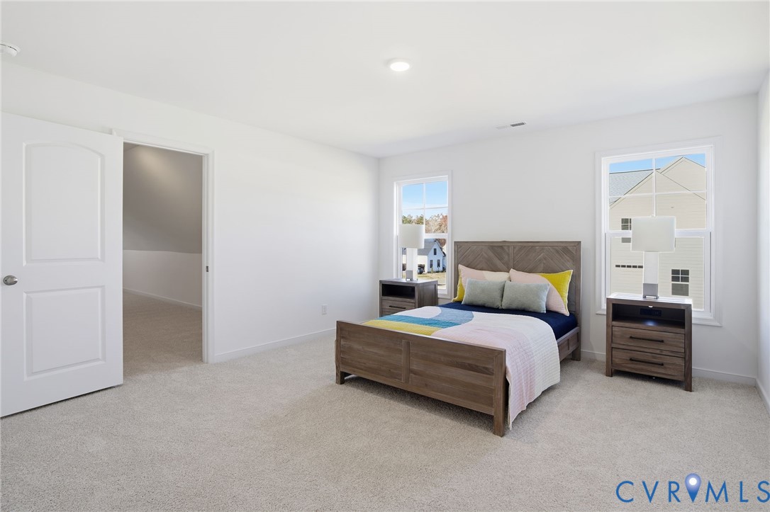 9991 Boschen Wds Place Chesterfield, VA 23832 - Photo 25 of 38 a spacious bedroom with a bed and a lamp