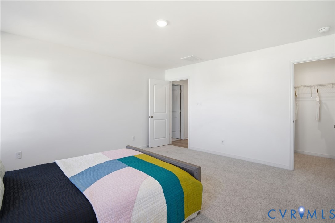 9991 Boschen Wds Place Chesterfield, VA 23832 - Photo 26 of 38 a bedroom with a bed and a painting on the wall