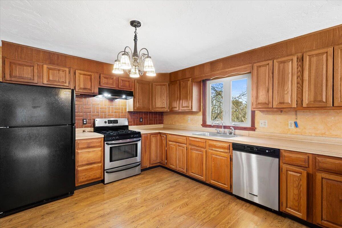 1094 County Road Cataumet, MA 02534 - Photo 11 of 42 a kitchen with a sink stove and refrigerator