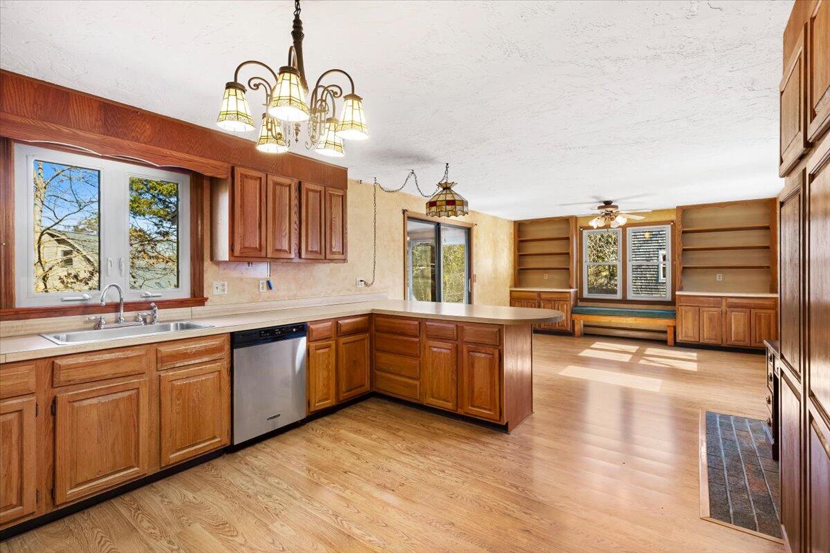 1094 County Road Cataumet, MA 02534 - Photo 12 of 42 a large kitchen with stainless steel appliances granite countertop a stove and cabinets with wooden floor