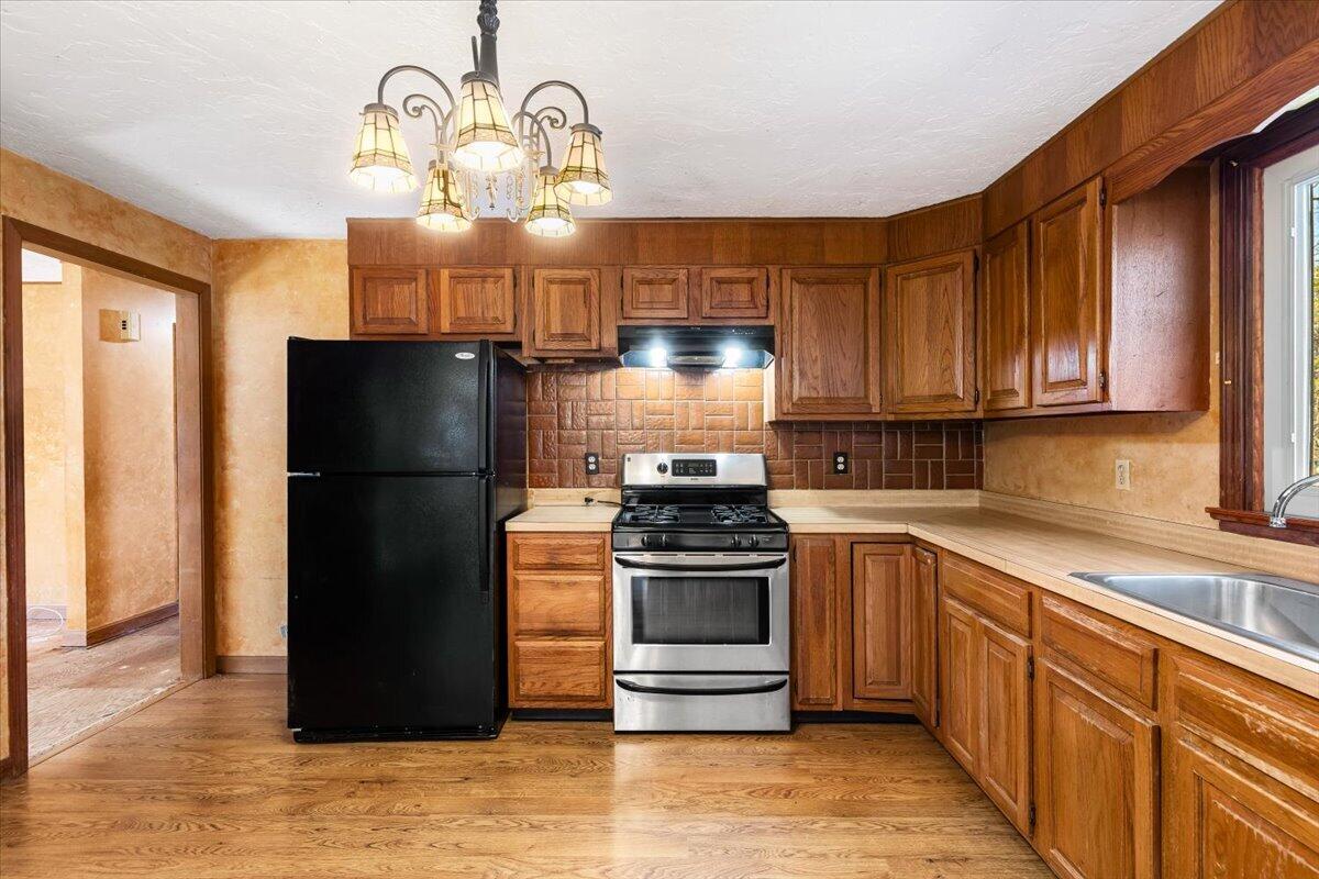 1094 County Road Cataumet, MA 02534 - Photo 14 of 42 a kitchen with a refrigerator and a sink