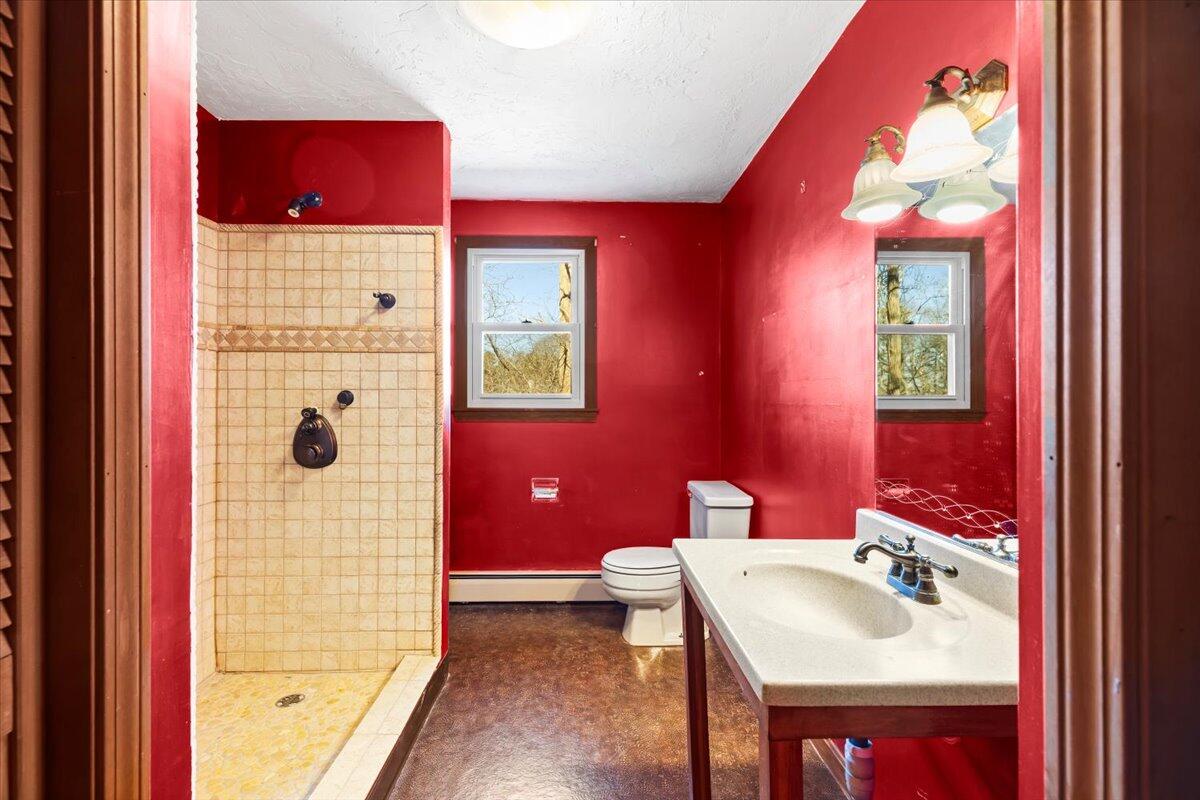 1094 County Road Cataumet, MA 02534 - Photo 23 of 42 a bathroom with a sink vanity tub and shower