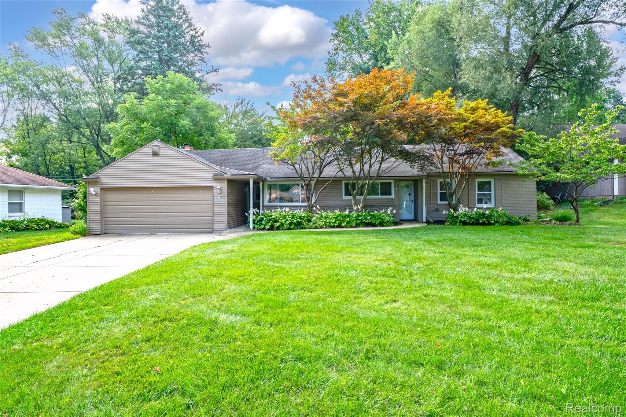 2329 Rutherford Road Bloomfield Hills, MI 48302 - Photo 1 of 46 Ranch-style residence featuring a two-car garage, concrete driveway, and mature landscaping