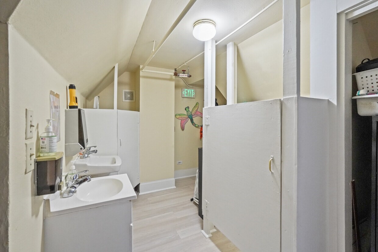1030 4th Street Rosenberg, TX 77471 - Photo 25 of 39 a bathroom with a sink a mirror and a shower