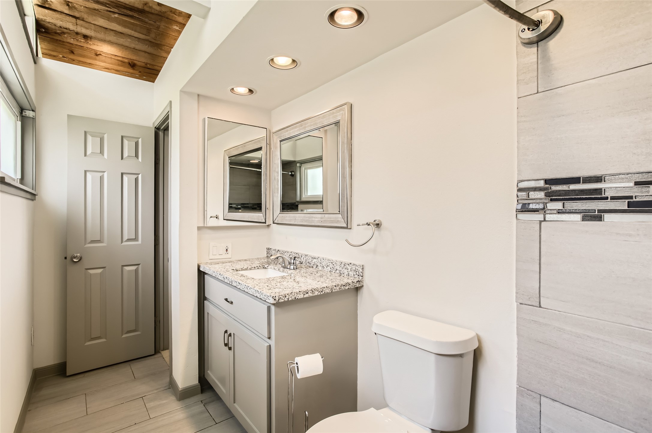 6509 Birdwood Road Houston, TX 77074 - Photo 19 of 26 a bathroom with a toilet sink and mirror