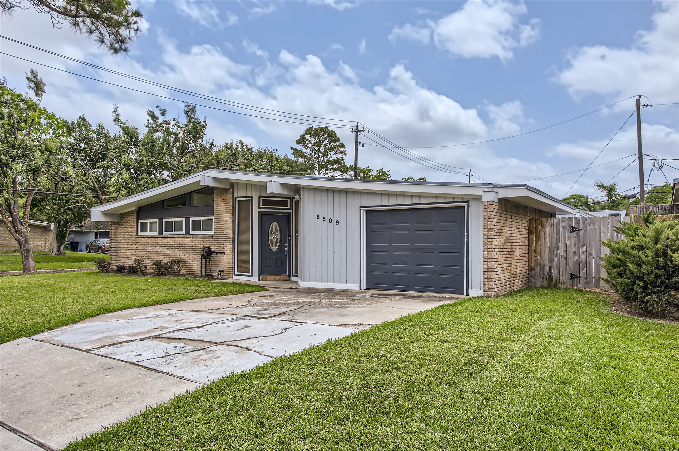 6509 Birdwood Road Houston, TX 77074 - Photo 2 of 26 a view of a house with a yard and plants