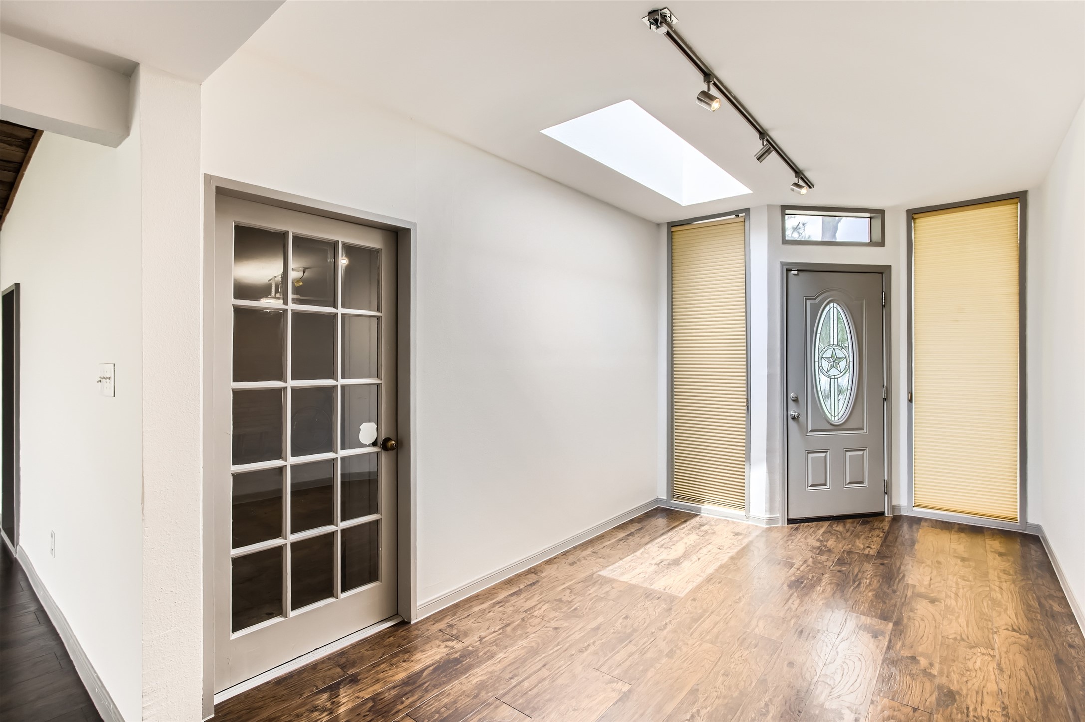 6509 Birdwood Road Houston, TX 77074 - Photo 4 of 26 a view of empty room with wooden floor and window