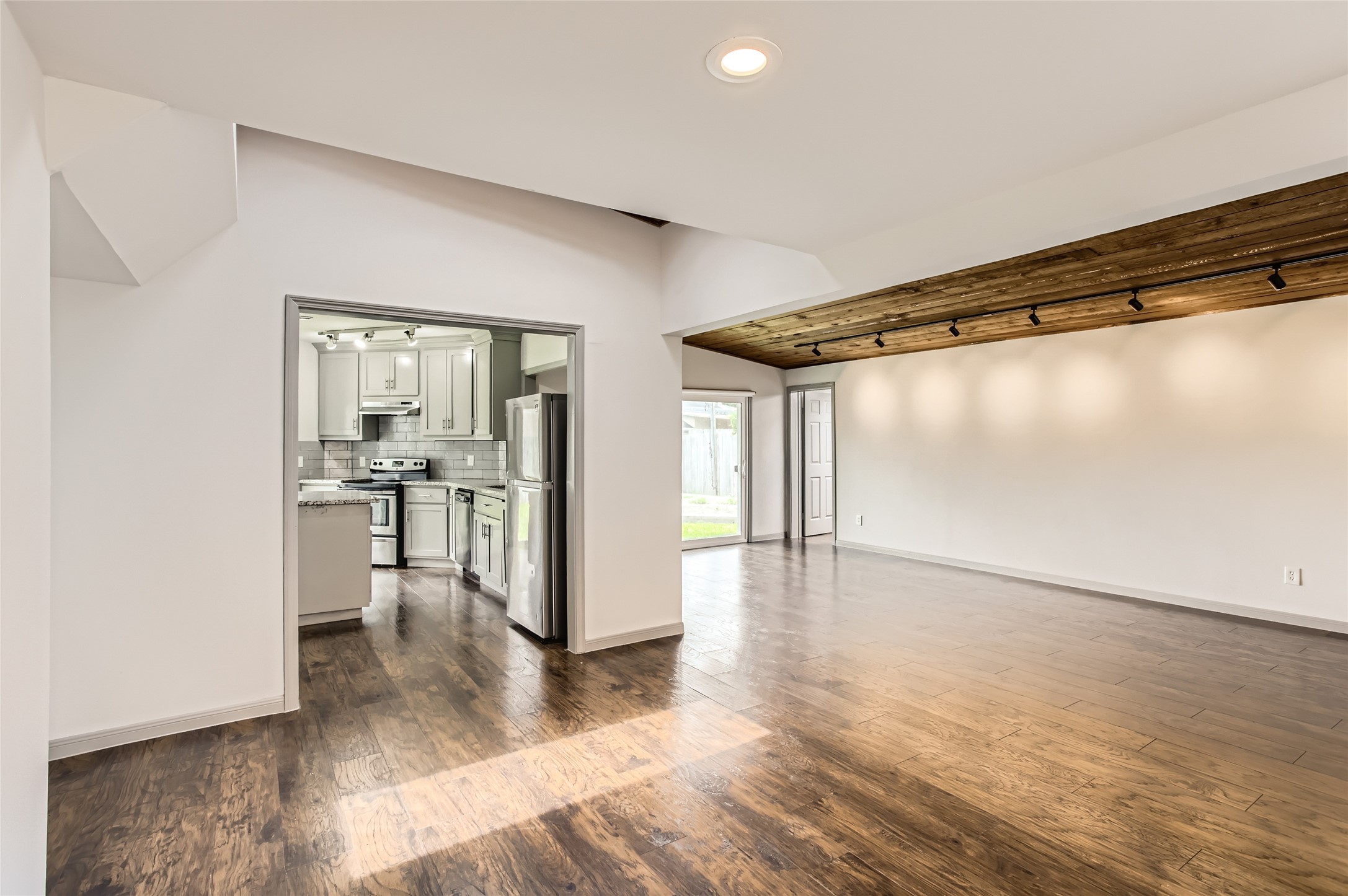 6509 Birdwood Road Houston, TX 77074 - Photo 5 of 26 a view of a room with wooden floor and a window