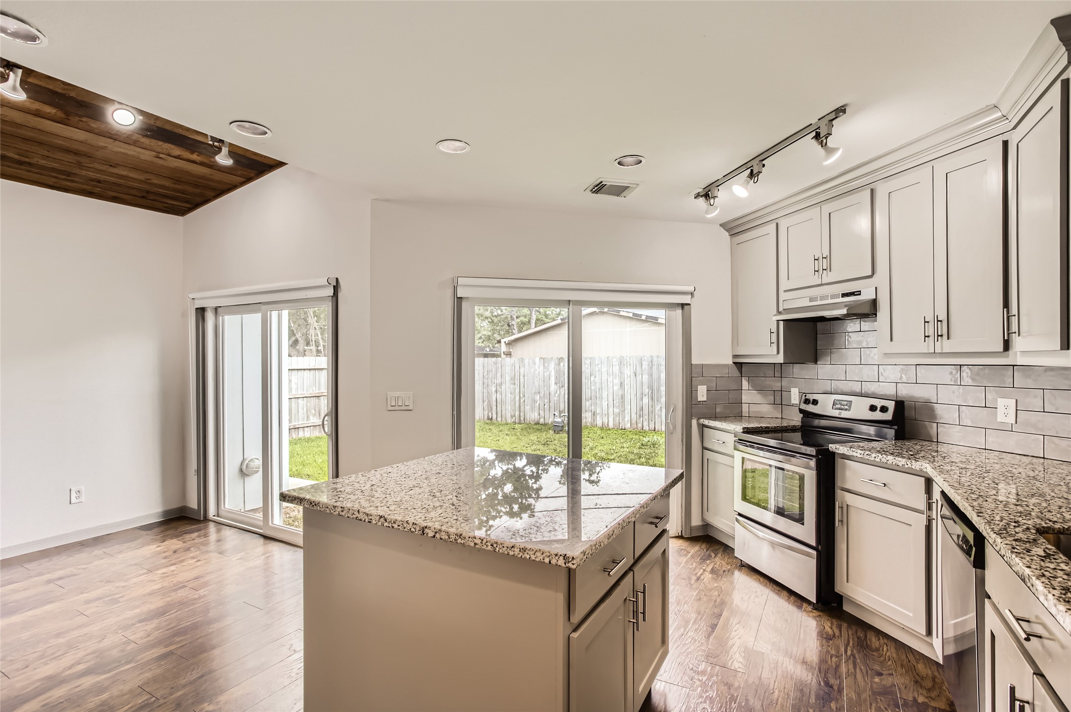 6509 Birdwood Road Houston, TX 77074 - Photo 9 of 26 a kitchen with granite countertop a stove and a sink