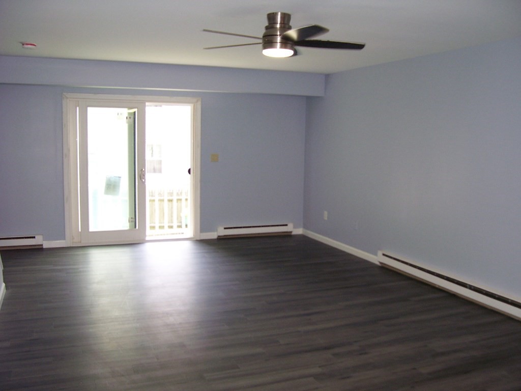 4 Balcomb Street, Unit 4 Salem, MA 01970 - Photo 12 of 38 a view of an empty room with wooden floor and a window