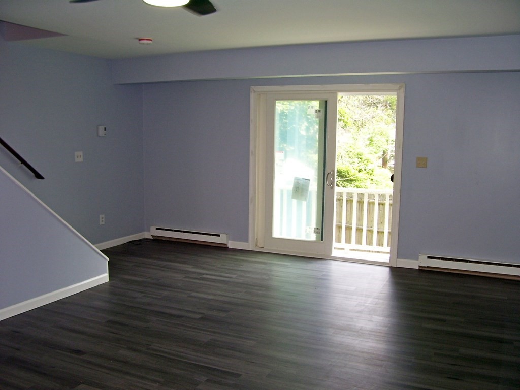 4 Balcomb Street, Unit 4 Salem, MA 01970 - Photo 13 of 38 a view of an empty room with wooden floor and a window
