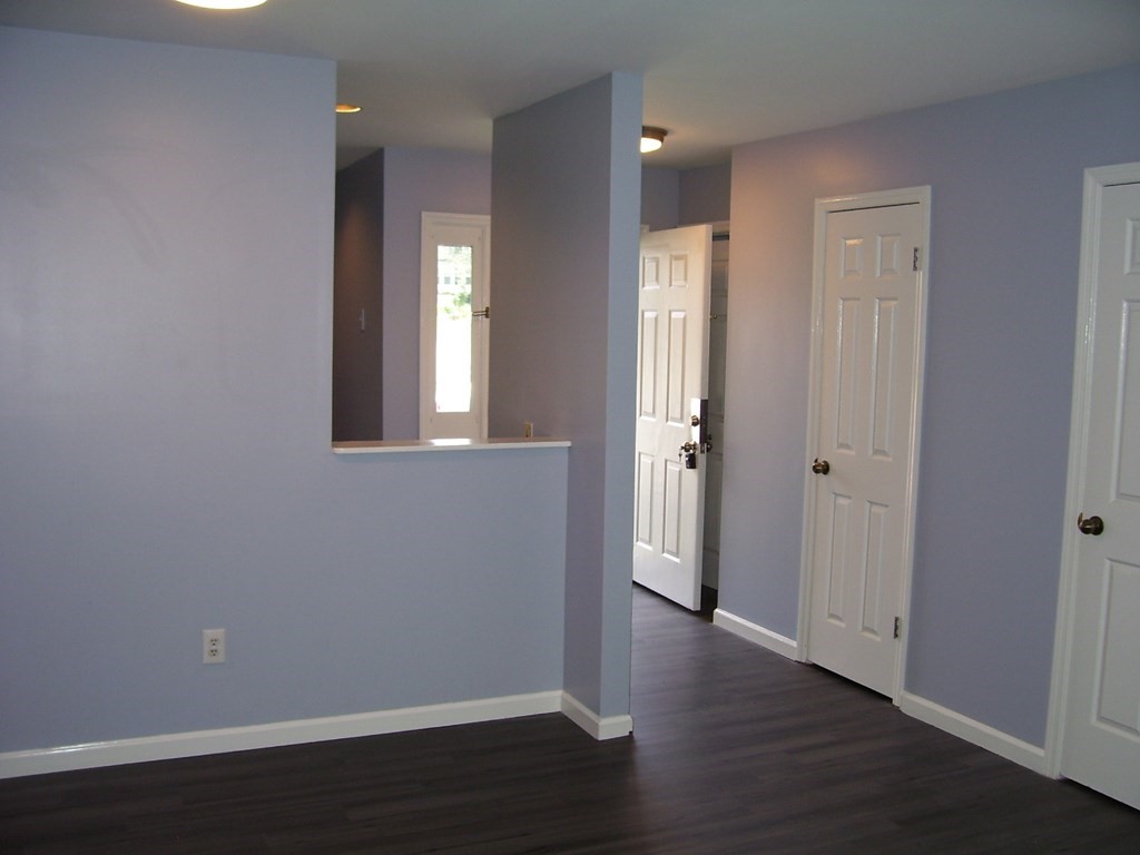 4 Balcomb Street, Unit 4 Salem, MA 01970 - Photo 16 of 38 an empty room with wooden floor and windows
