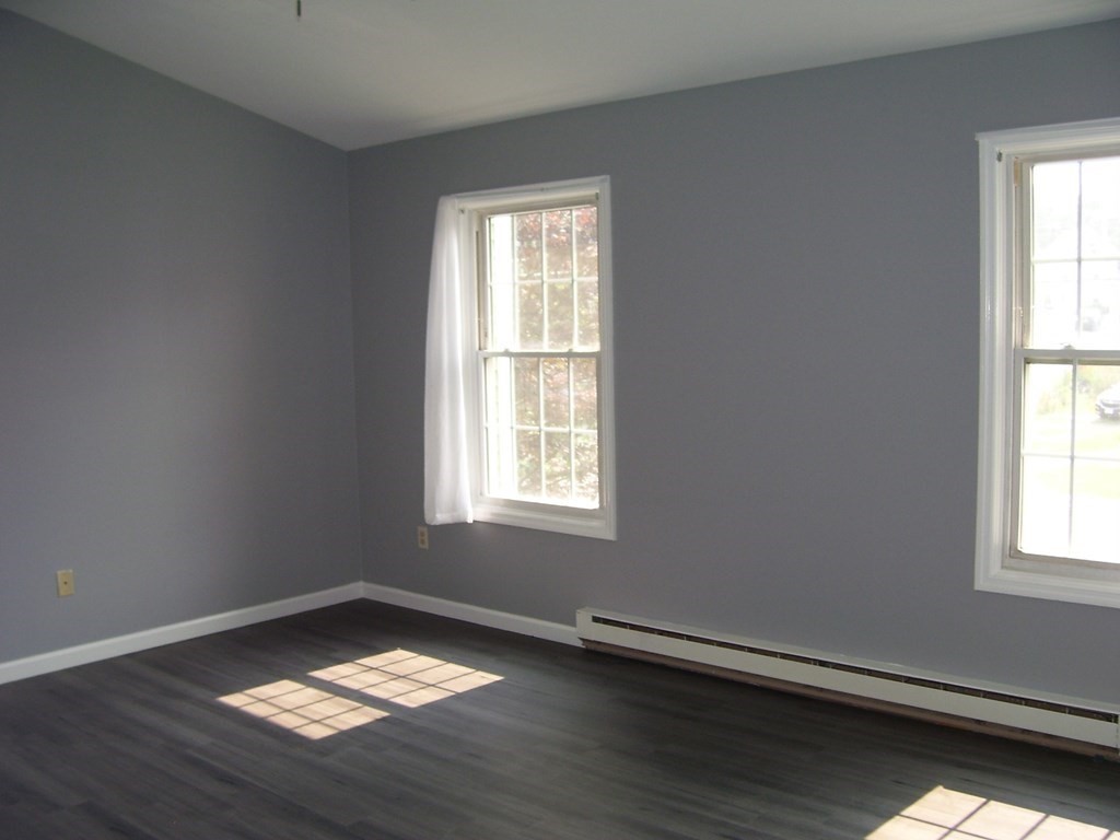 4 Balcomb Street, Unit 4 Salem, MA 01970 - Photo 20 of 38 a view of an empty room with wooden floor and a window