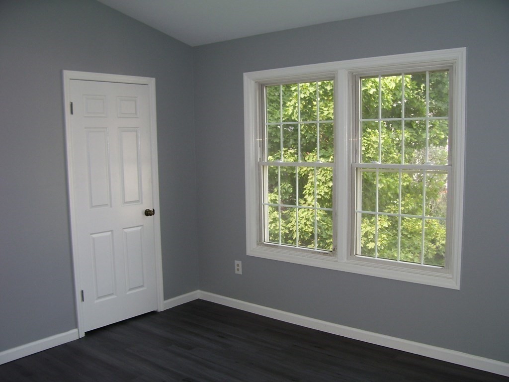 4 Balcomb Street, Unit 4 Salem, MA 01970 - Photo 23 of 38 a view of an empty room with wooden floor and a window