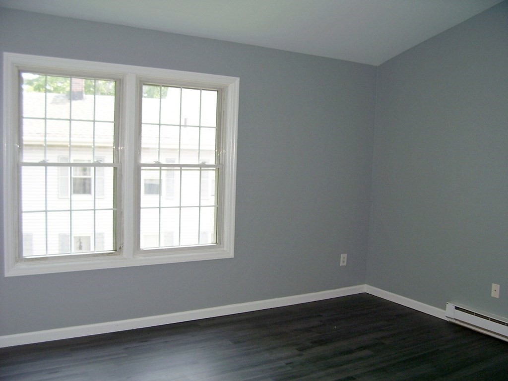 4 Balcomb Street, Unit 4 Salem, MA 01970 - Photo 26 of 38 an empty room with wooden floor and windows