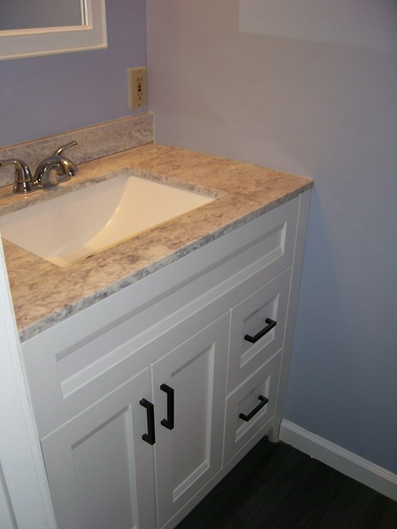 4 Balcomb Street, Unit 4 Salem, MA 01970 - Photo 30 of 38 a bathroom with a granite countertop sink and vanity