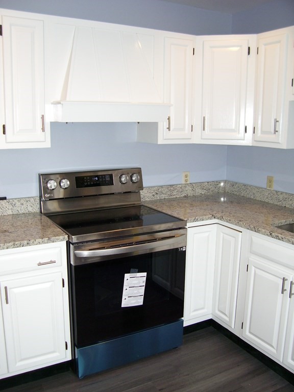 4 Balcomb Street, Unit 4 Salem, MA 01970 - Photo 7 of 38 a stove top oven sitting inside of a kitchen