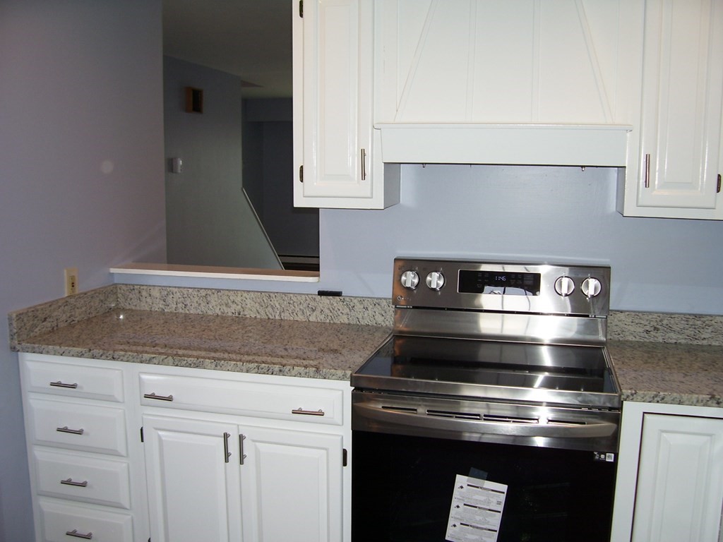 4 Balcomb Street, Unit 4 Salem, MA 01970 - Photo 8 of 38 a stove top oven sitting inside of a kitchen