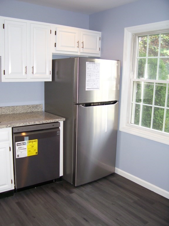 4 Balcomb Street, Unit 4 Salem, MA 01970 - Photo 9 of 38 a white refrigerator freezer sitting in a kitchen