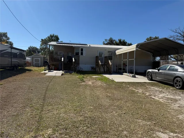 a view of a house with a yard and garage