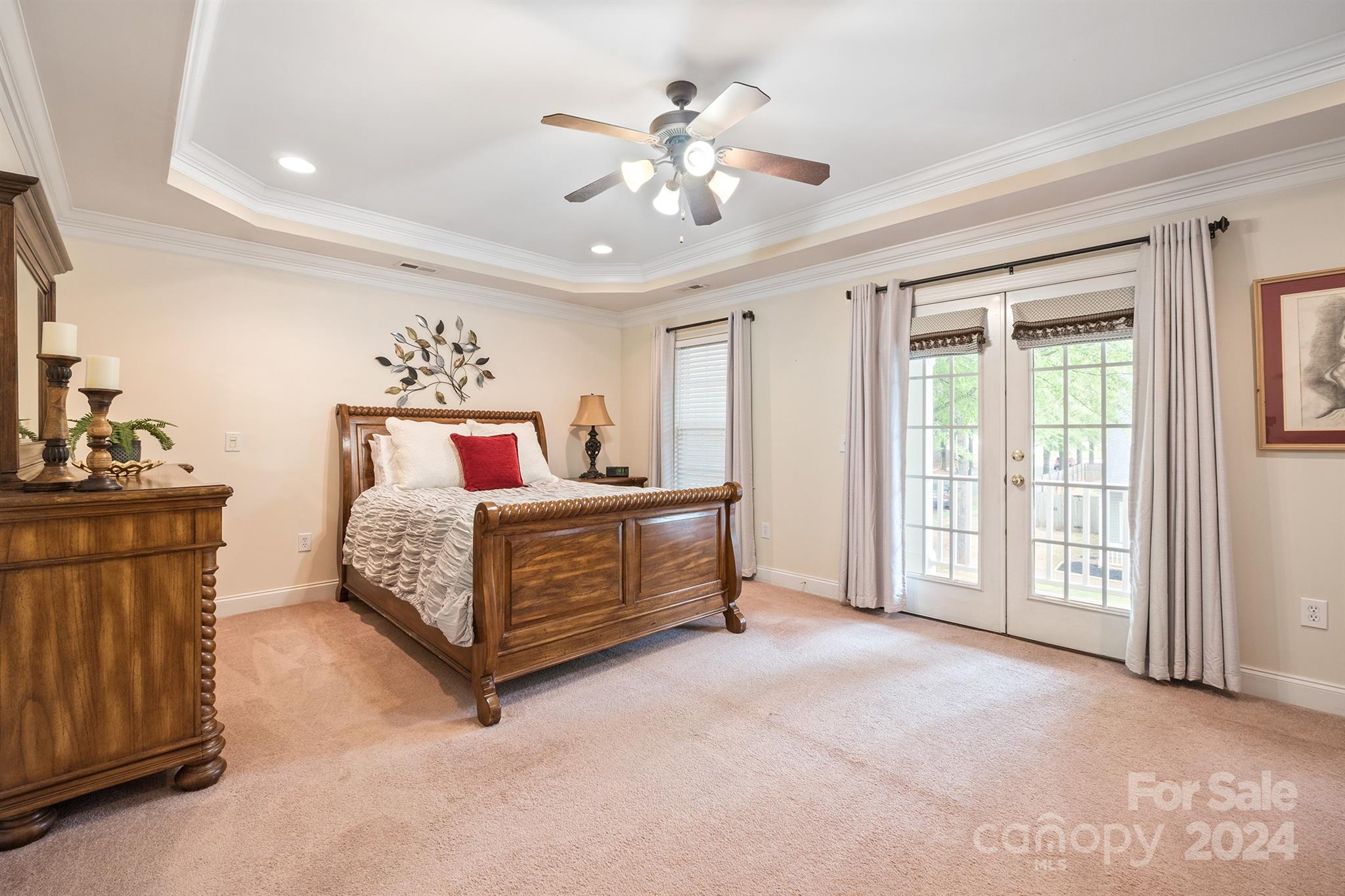 12804 Windyedge Road Huntersville, NC 28078 - Photo 25 of 42 a spacious bedroom with a bed and a chandelier
