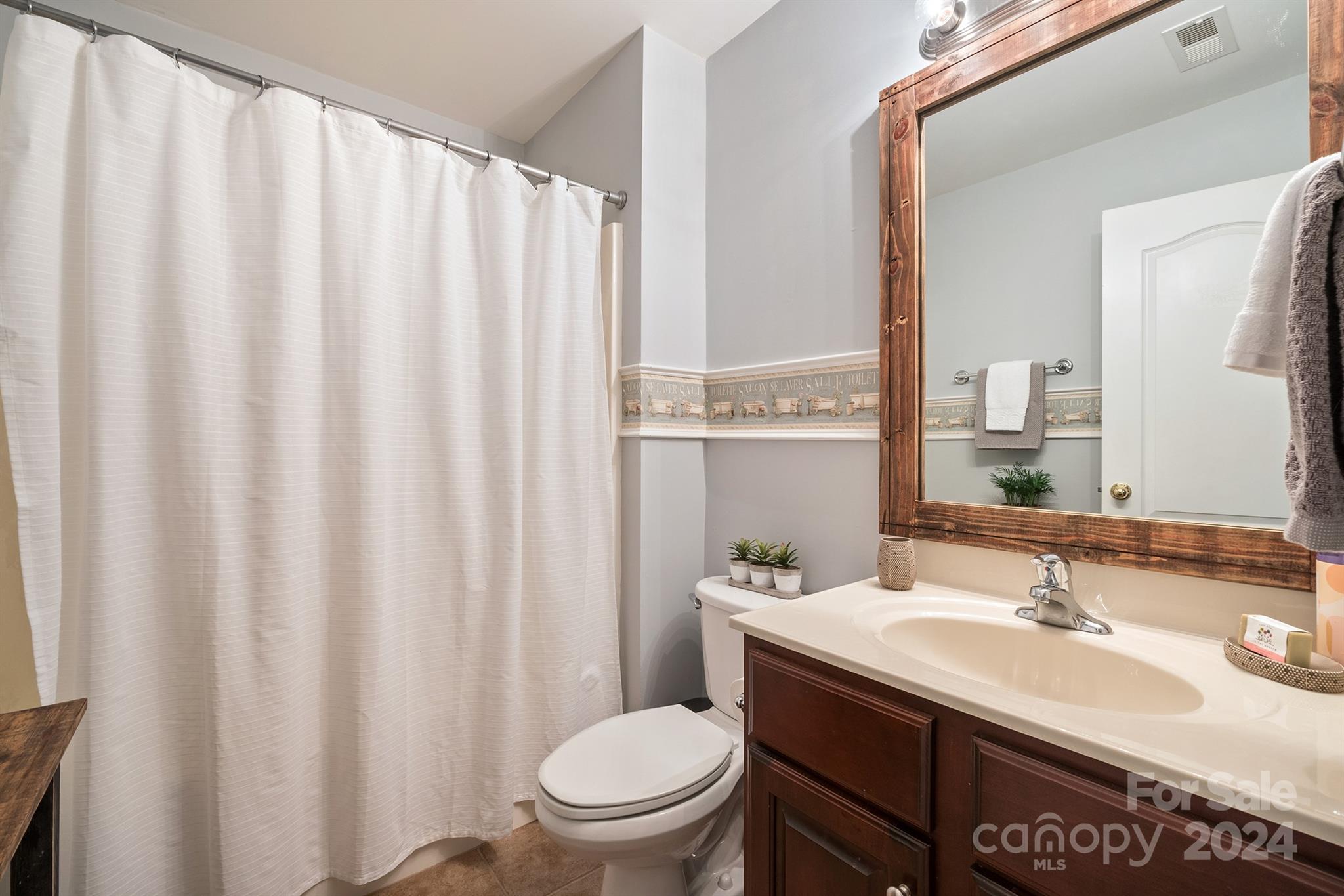 12804 Windyedge Road Huntersville, NC 28078 - Photo 33 of 42 a bathroom with a sink toilet and mirror