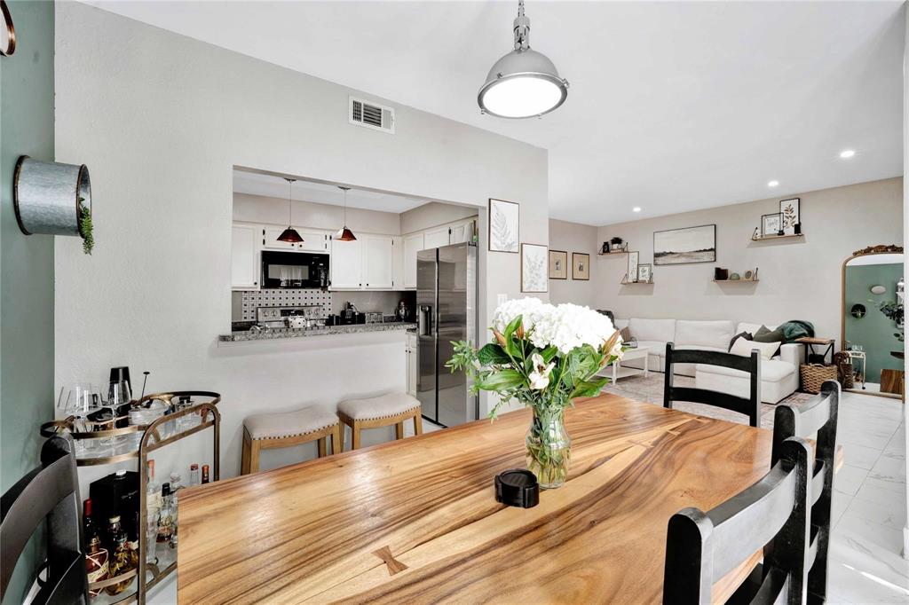 8518 Coppertowne Lane Dallas, TX 75243 - Photo 11 of 32 a dining room with furniture and a potted plant
