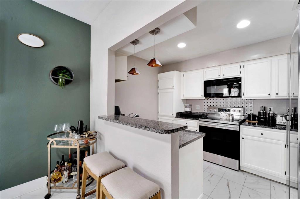 8518 Coppertowne Lane Dallas, TX 75243 - Photo 12 of 32 a kitchen with a sink appliances and cabinets
