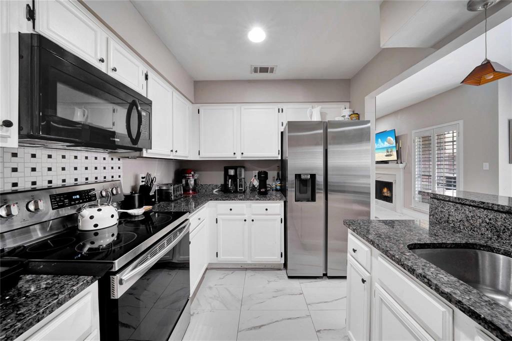 8518 Coppertowne Lane Dallas, TX 75243 - Photo 14 of 32 a kitchen with granite countertop a sink stove and refrigerator