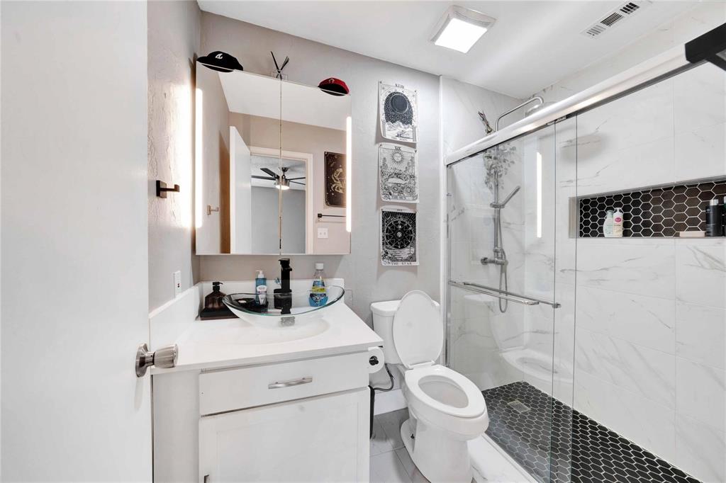 8518 Coppertowne Lane Dallas, TX 75243 - Photo 18 of 32 a bathroom with a sink toilet and shower