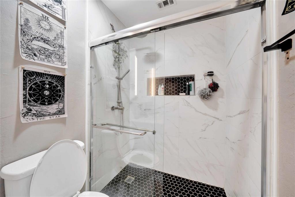 8518 Coppertowne Lane Dallas, TX 75243 - Photo 19 of 32 a bathroom with a shower toilet and sink