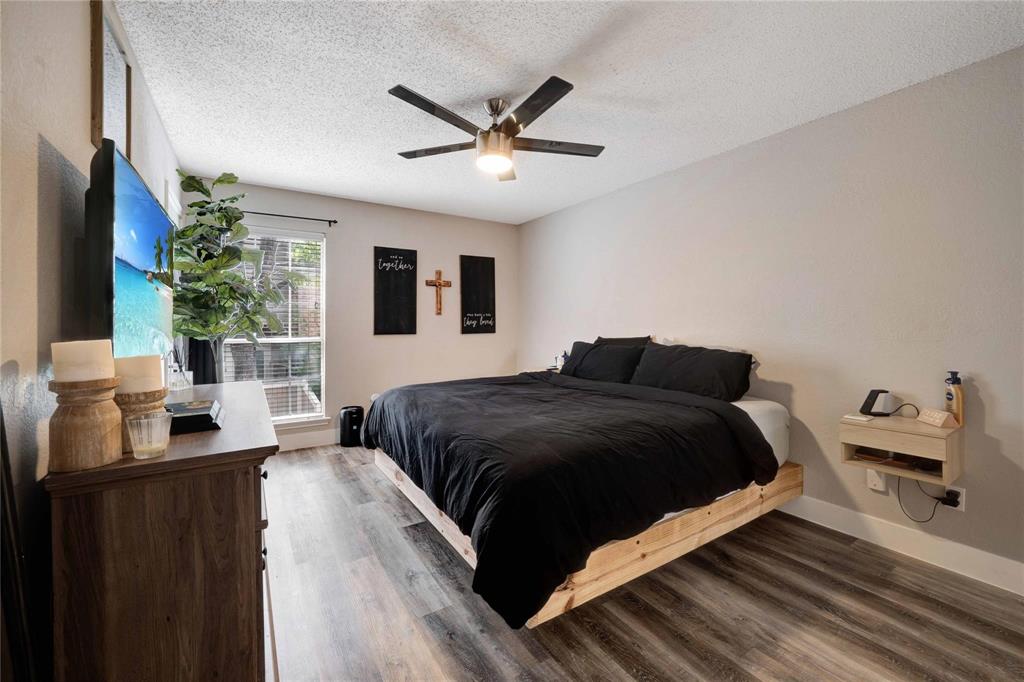 8518 Coppertowne Lane Dallas, TX 75243 - Photo 20 of 32 a bedroom with a bed window and a flat screen tv