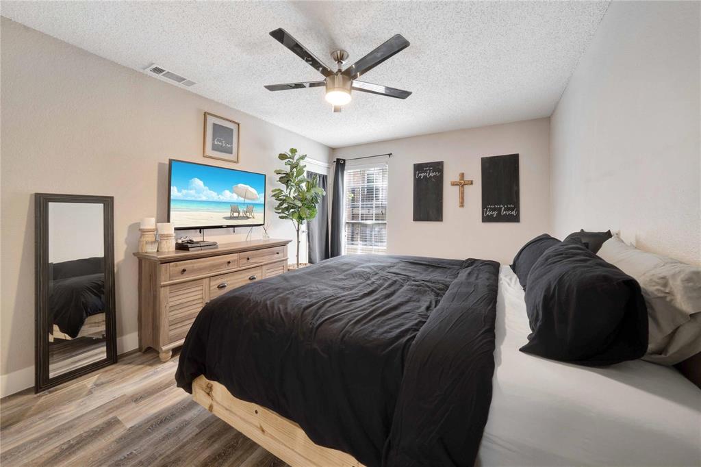 8518 Coppertowne Lane Dallas, TX 75243 - Photo 21 of 32 a bedroom with a bed and a flat screen tv